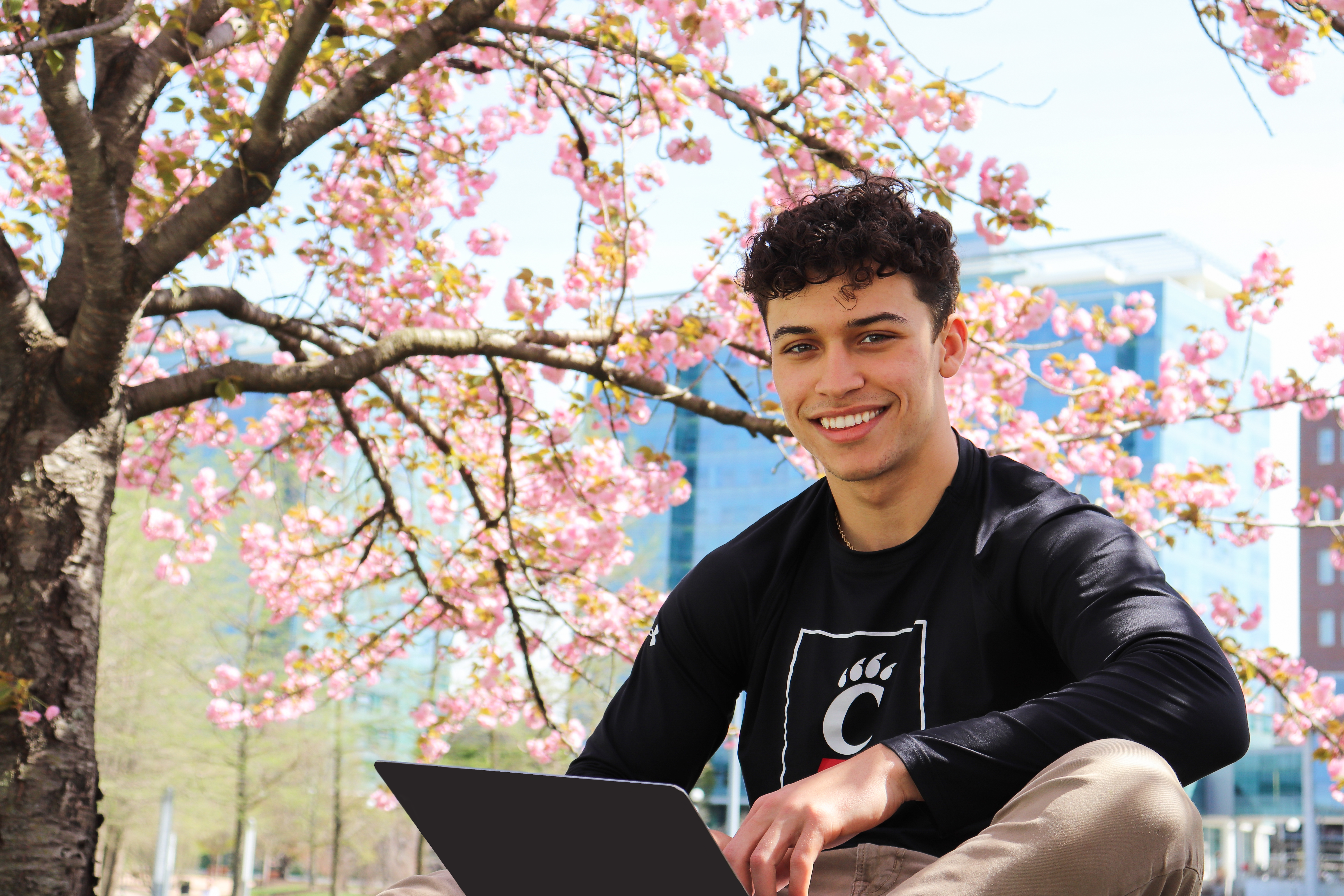 Students holding up UC on study abroad trip